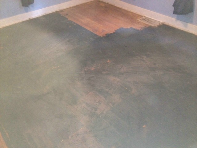 black paint stains on a hardwood floor