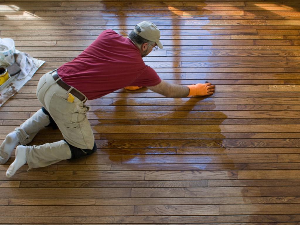 a fabulous floors milwaukee technician refinishing a hardwood floor